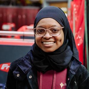 Jannah Madyun smiling in a welding lab.