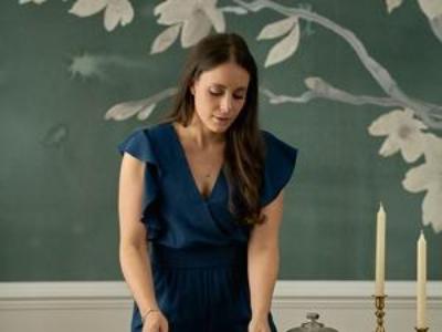 Victoria laying out plates on a designed tablescape.
