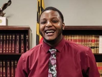 Keshawn Johnson holds a stuffed Swoop mascot after being sworn in as student member of board.