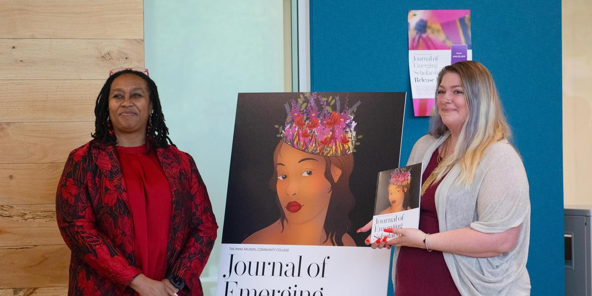 Emily Archer at the Journal of Emerging Scholars event receiving her copy with Dr. Millner.