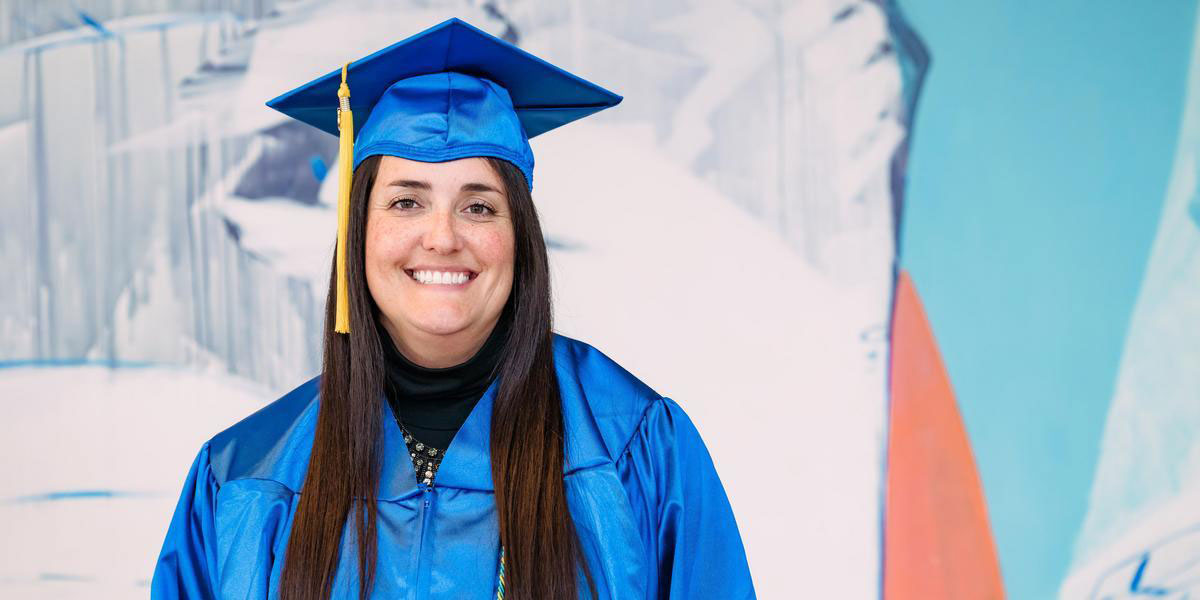 Headshot of Kyla Skinner in commencement regalia