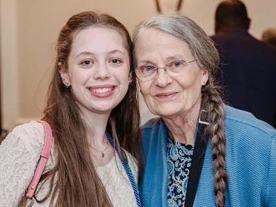 Brynn posing with an older woman at the Impact and Excellence Awards.