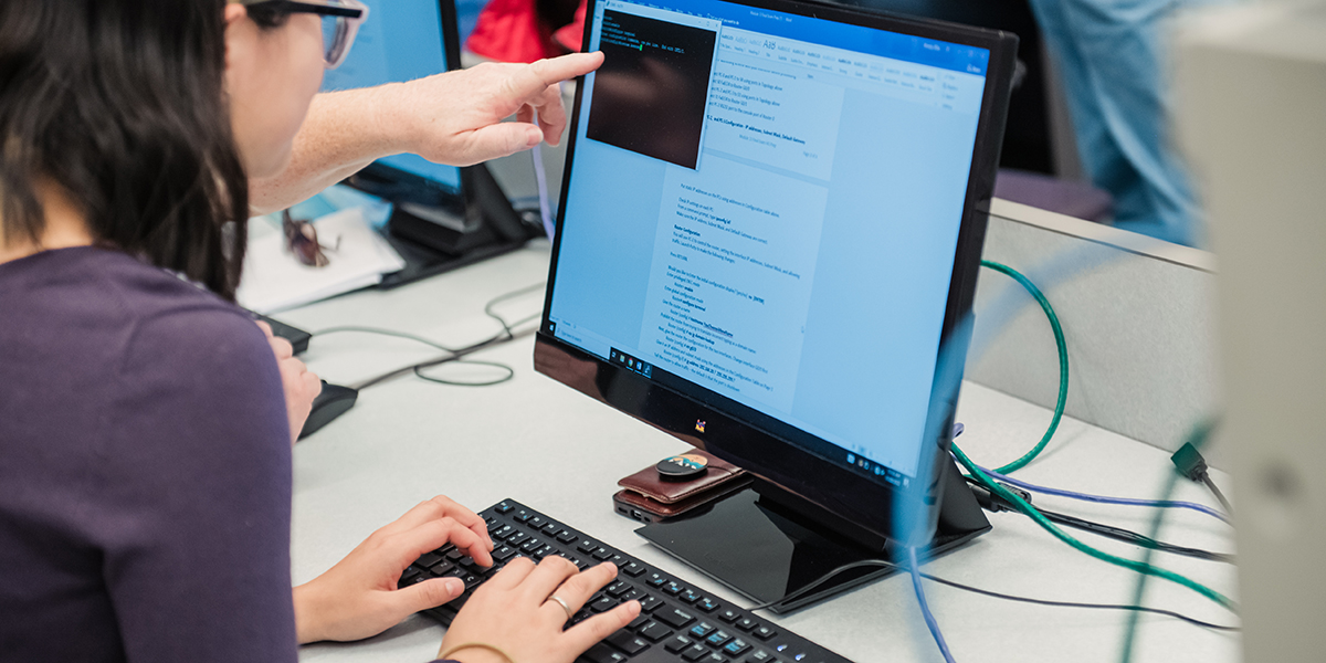 Cybersecurity student using a computer