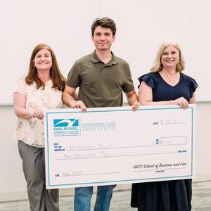 A student poses for a photo with a check and Business and Law Assistant Dean and ESI professor Stephanie Goldenberg.