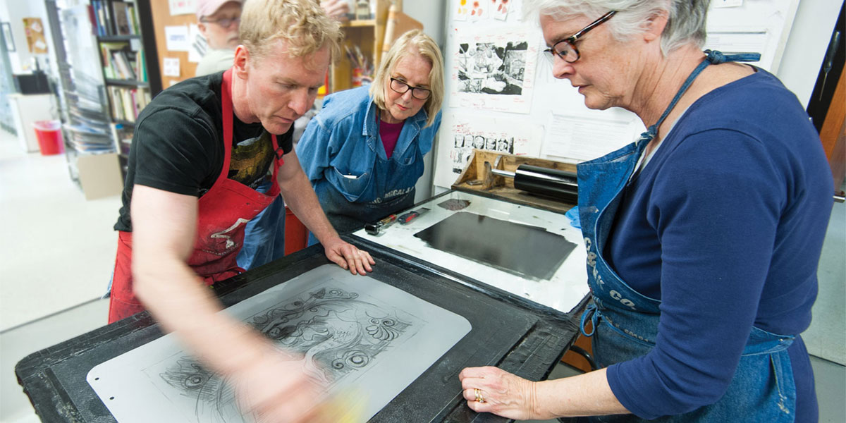 AACC art students learn to silkscreen.