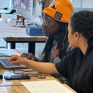 Students looking at laptop