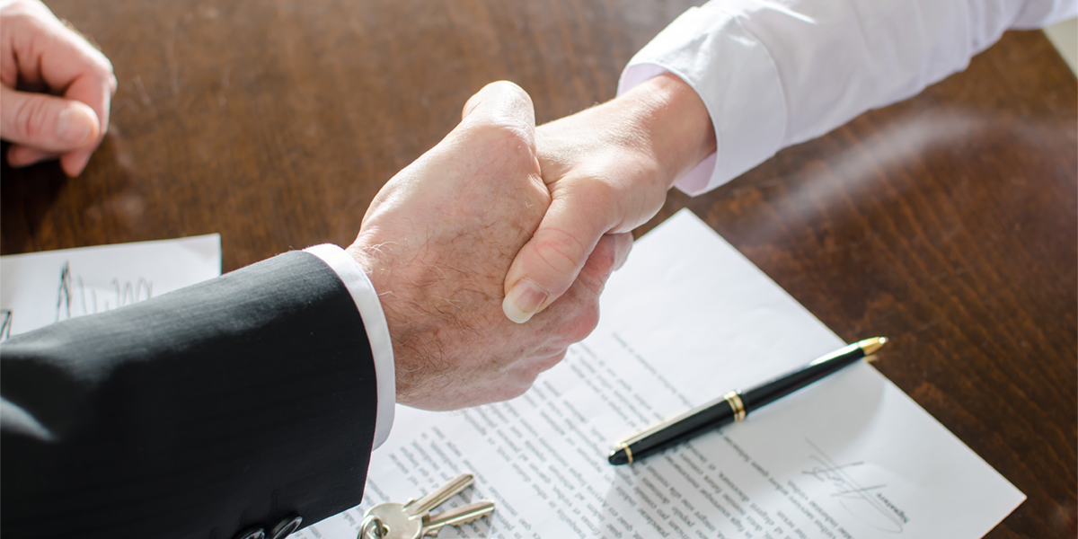 Shaking Hands with contract and keys