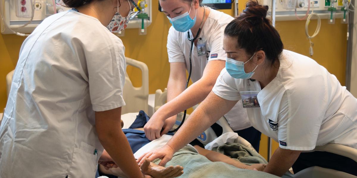 Nursing students in lab instruction.
