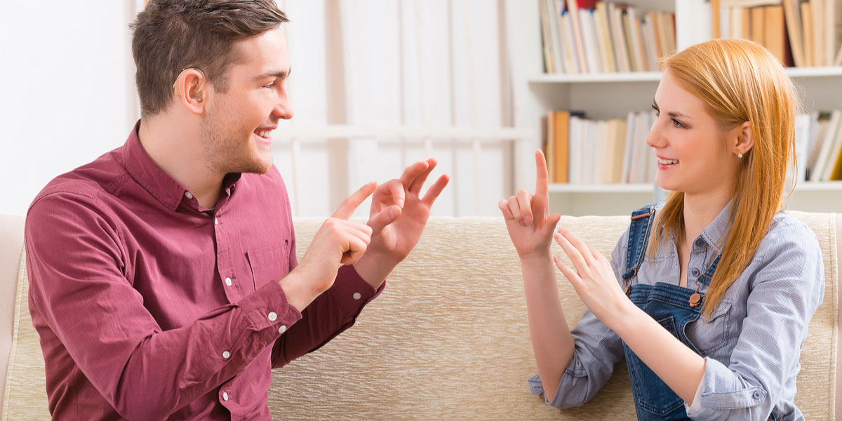 Two students learning sign language