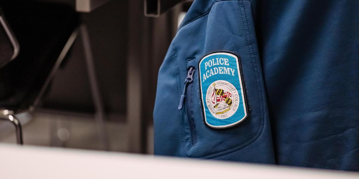 No video playback functionality. Police academy jacket and patch.