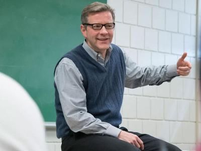 Male faculty member in front of the classroom.