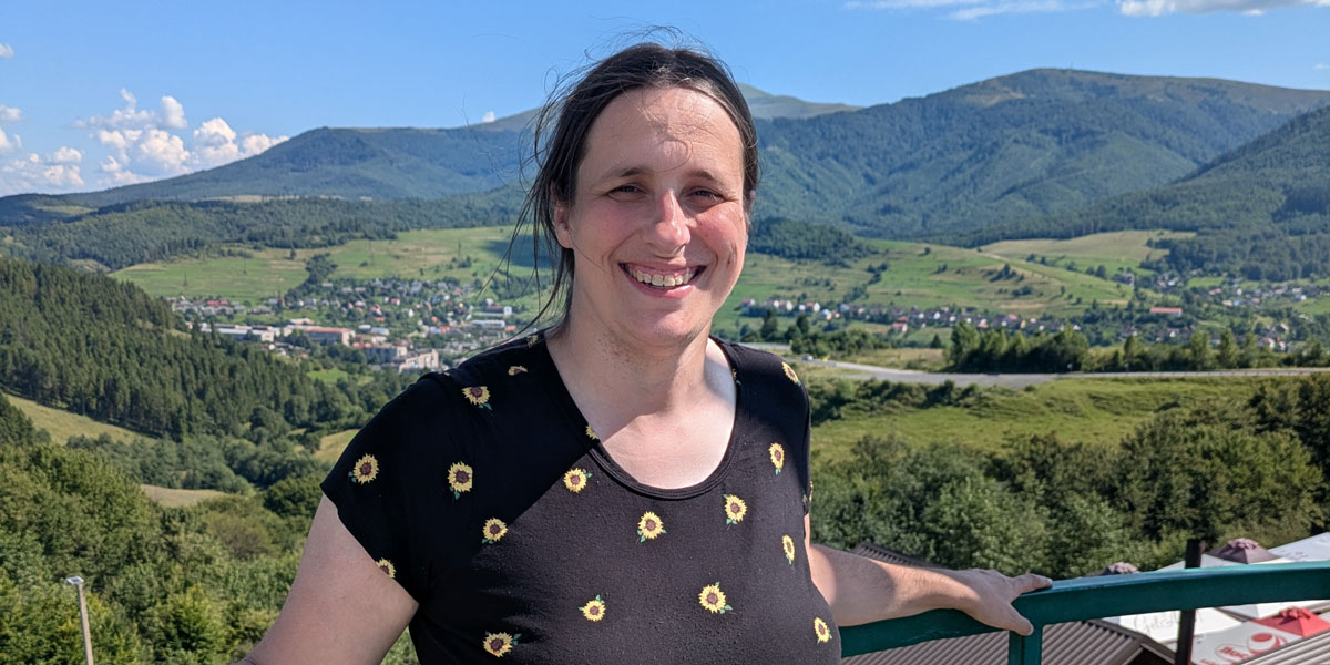 Susan Ficken standing outside with a mountain backdrop
