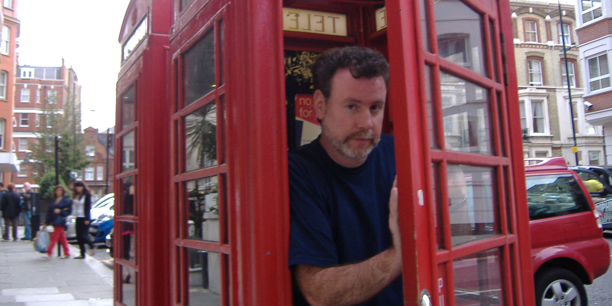 Brian Patrick Riley inside of a phone booth.