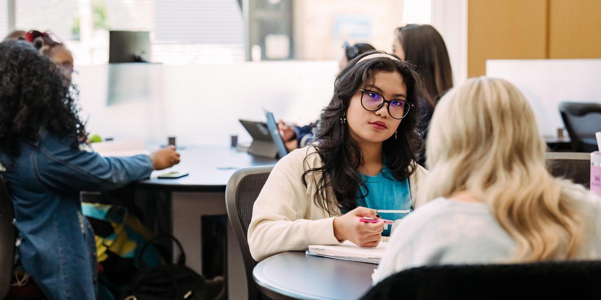Students talking to each other in Library.