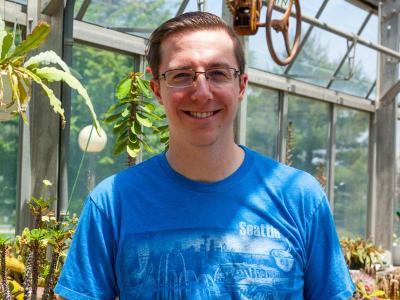 Chris Swift standing in front of plants.